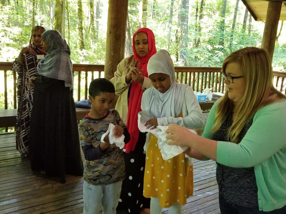 Alexis teaching children in the park shelter