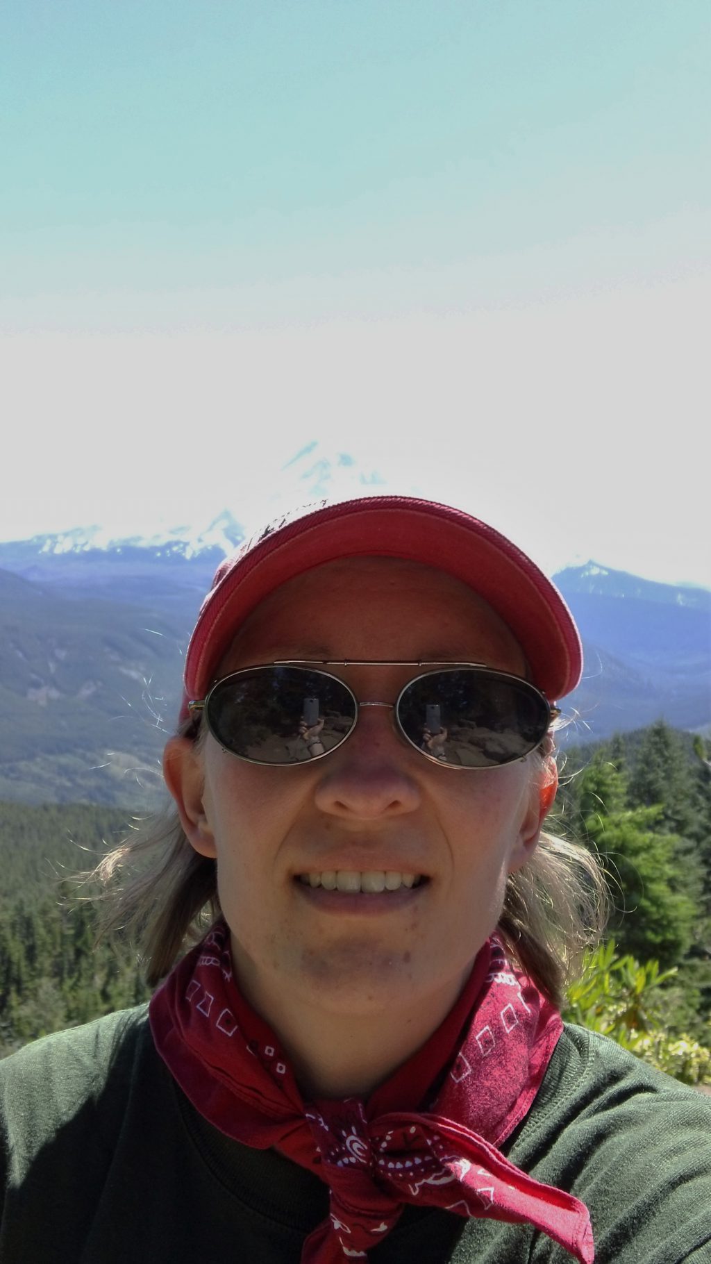 Close up of Erin Miller outdoors with a mountain in the background.