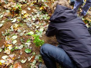 Corrina demonstrating how to plant.