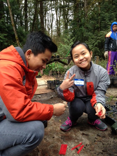 Two volunteers labeling plants