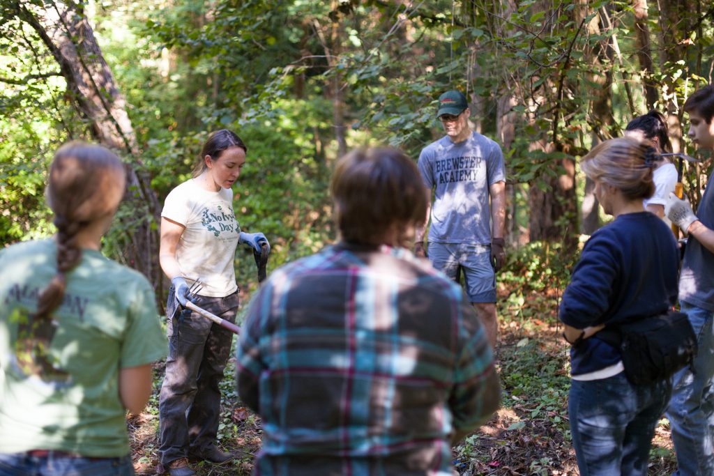 Adra instructing a group of volunteers.