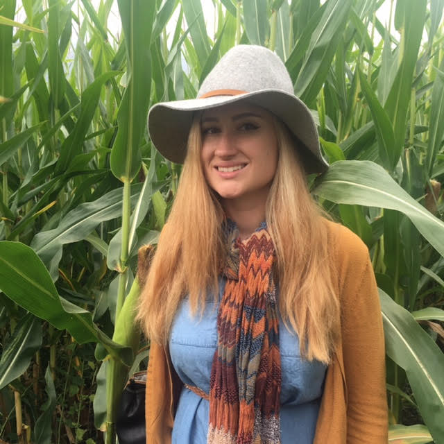 Jackie Brenner standing in a corn field.